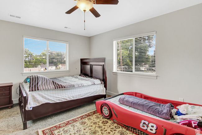 Bedroom featuring a ceiling fan and carpet | Image 18