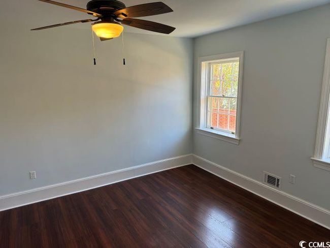 Spare room with dark hardwood / wood-style flooring and ceiling fan | Image 18