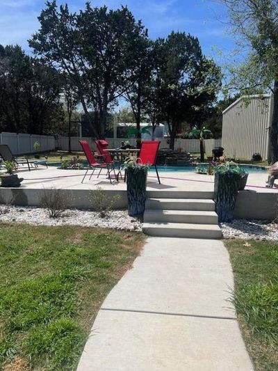 View of yard with a patio and a fenced in pool | Image 3