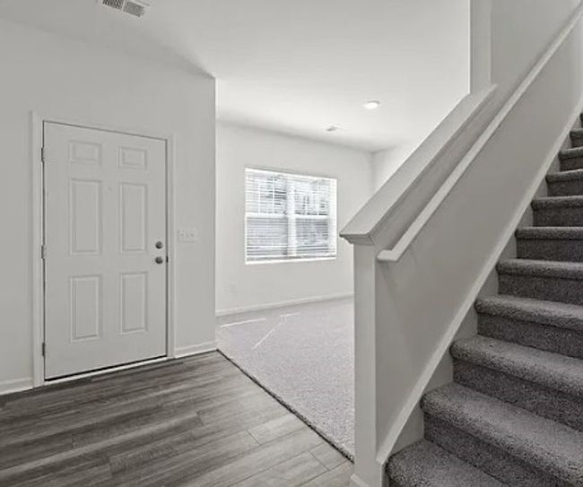 Foyer featuring stairs and wood finished floors | Image 8