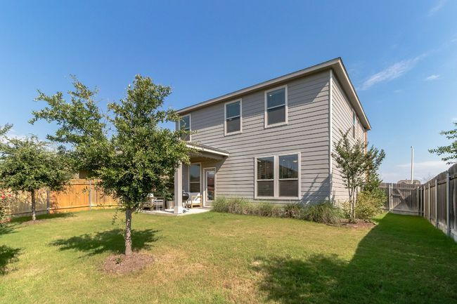 Rear view of property featuring a fenced backyard and a patio | Image 27