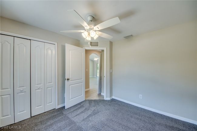 Unfurnished bedroom featuring a closet, carpet flooring, visible vents, and baseboards | Image 37