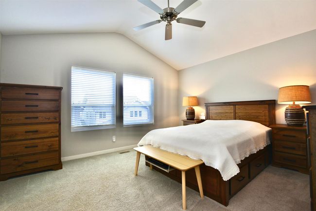 Bedroom with vaulted ceiling, carpet flooring, and a ceiling fan | Image 23