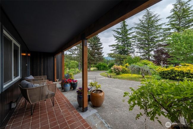 Whether you're sipping coffee under the covered front porch, strolling the woodland trails, or expanding your garden oasis, this is true serenity—complete with wildlife, clean air, and a backdrop of Cascade foothills. Just minutes from Bellingham, yet a world away. | Image 32