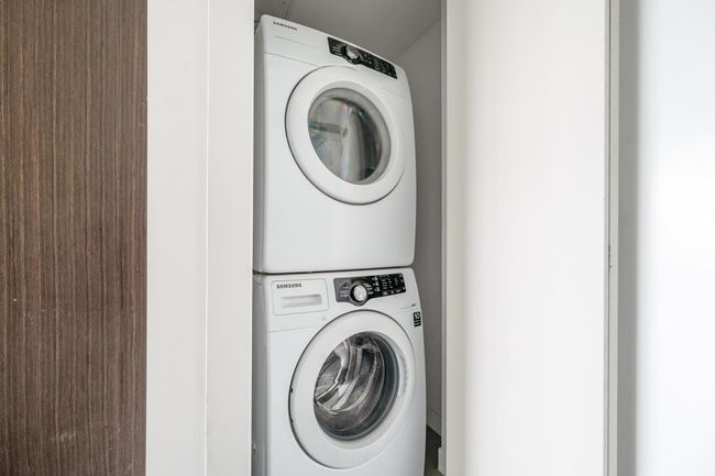 Laundry room featuring stacked washer / drying machine | Image 20