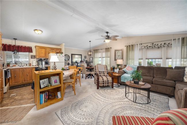 Living room featuring light colored carpet and a ceiling fan | Image 14