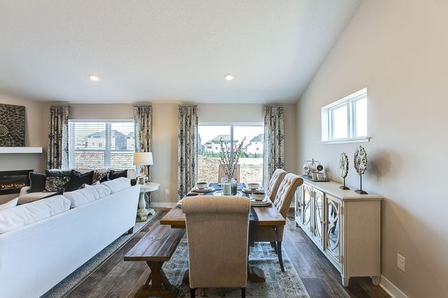 Bright light streams through the patio doors into the dining space. Photos of model home. Colors and options may vary. Ask Sales Agent for details. | Image 9