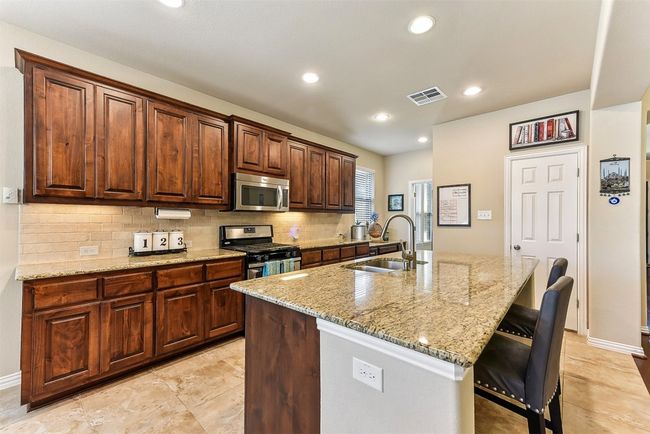 With an abundance of cabinets, counter space, and a large center island, this kitchen was designed to handle it all, from quick breakfasts to holiday cooking marathons | Image 10