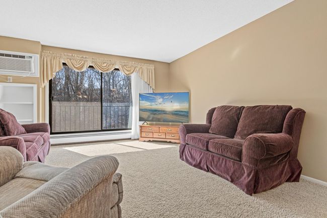 Open-Concept Living Area with Large Window and Natural Light | Image 10