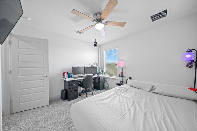 Bedroom featuring visible vents, ceiling fan, baseboards, and carpet floors | Image 25