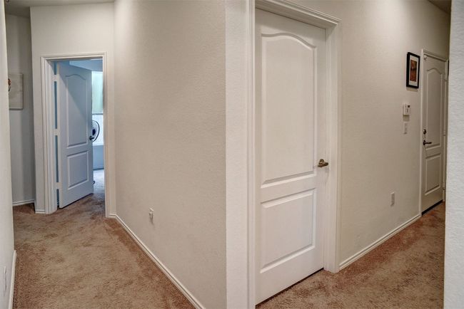 Hall with light carpet and baseboards | Image 26
