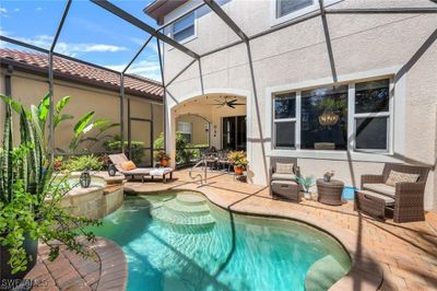 View of pool featuring a patio, ceiling fan, a lanai, and an outdoor hangout area | Image 2