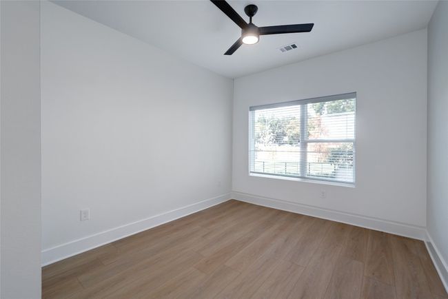 Spare room with wood finished floors, a ceiling fan, and baseboards | Image 11