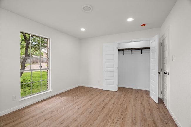 Unfurnished bedroom featuring wood finished floors, baseboards, recessed lighting, and a closet | Image 19