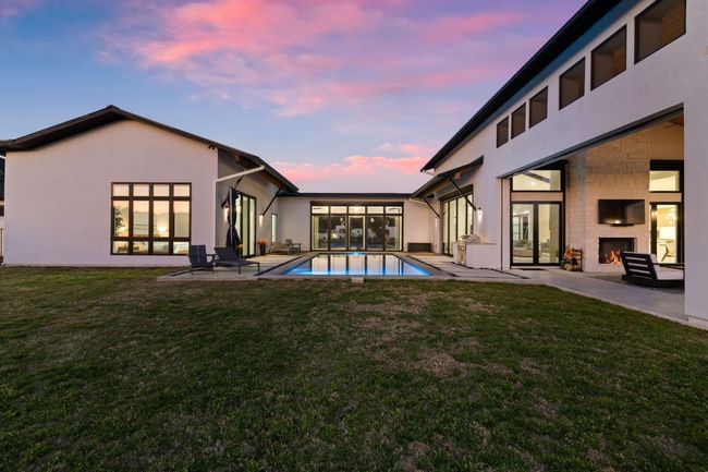 Rear view of property with a private back yard, a patio, pool, and an out door fireplace | Image 4