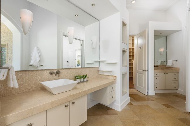 Bathroom featuring tasteful backsplash, vanity, a walk in closet, baseboards, and recessed lighting | Image 14