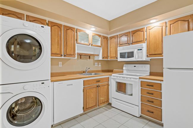Kitchen Featuring Wood-Toned Cabinets & Ample Storage | Image 6
