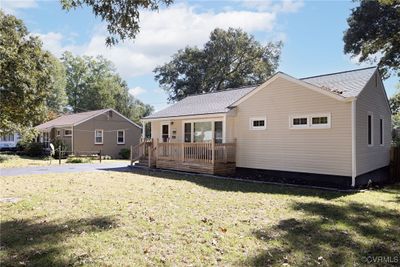 Rear view of house with a yard and a deck | Image 2