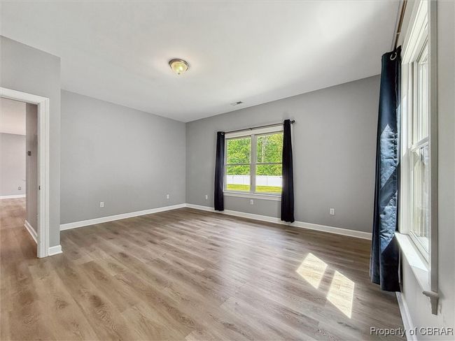 Unfurnished bedroom with light wood-style floors and baseboards | Image 24