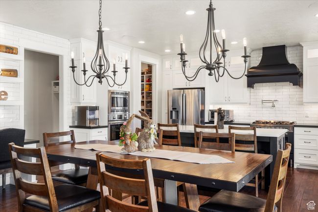 Dining room featuring recessed lighting, an inviting chandelier, and dark wood finished floors | Image 14