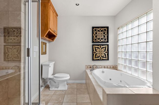 Bathroom with whirlpool tub and shower | Image 12