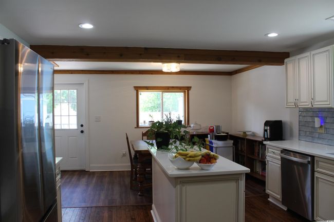 Kitchen with appliances with stainless steel finishes, healthy amount of natural light, light countertops, dark wood-style flooring, and recessed lighting | Image 14