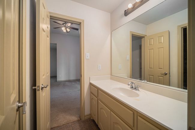Bathroom with ceiling fan, vanity, and tile patterned floors | Image 25