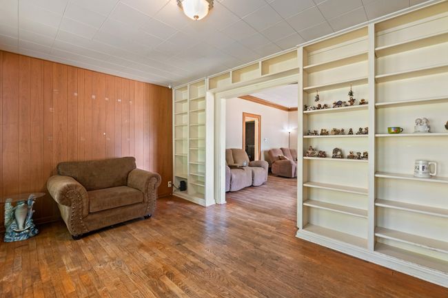 Living area featuring wood walls and wood finished floors | Image 21