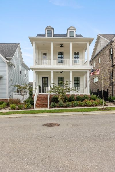 Welcome home to this timeless classic white house with black windows and double covered front porches! | Image 1