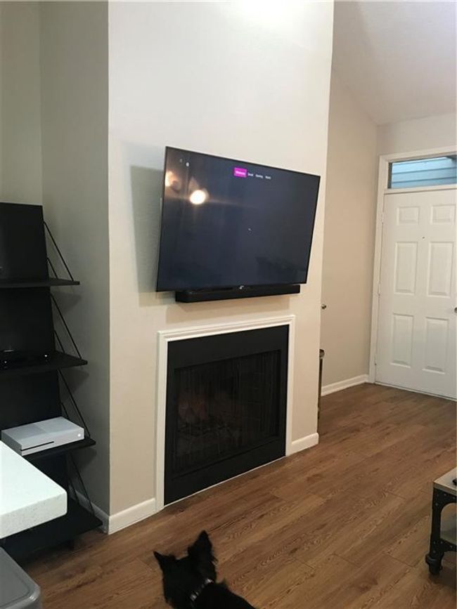 Living area featuring wood finished floors and a fireplace | Image 11