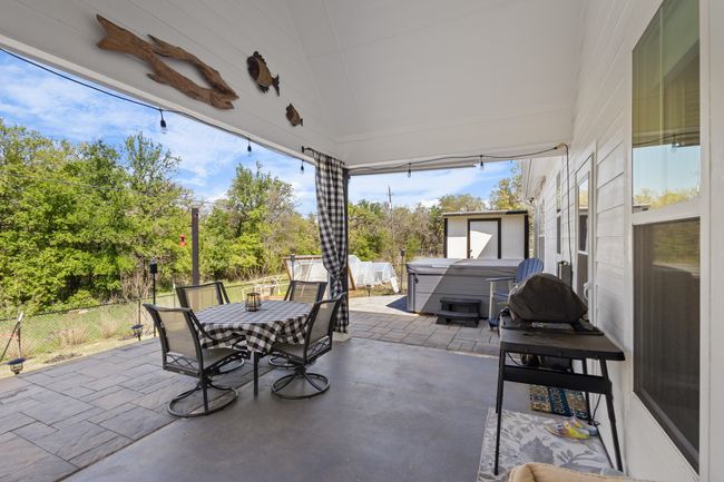 View of patio / terrace featuring outdoor dining space, fence, and a hot tub | Image 37