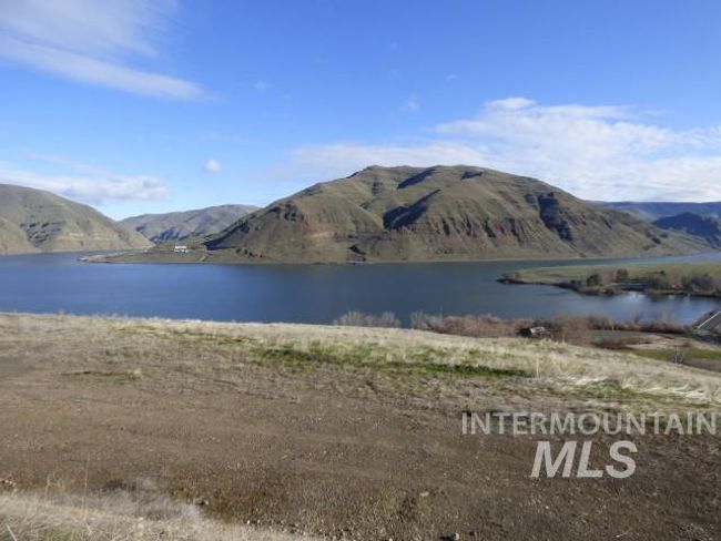 View of mountain backdrop with a nearby body of water | Image 5