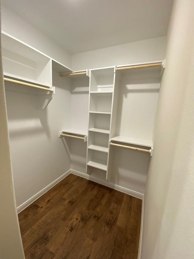 Spacious closet featuring dark wood finished floors | Image 12