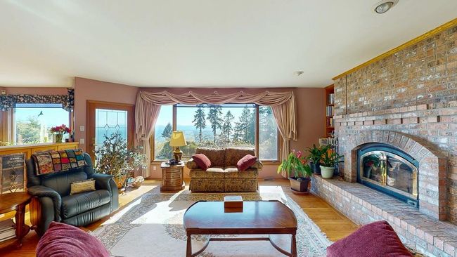 Living area with a fireplace and real oak flooring | Image 19