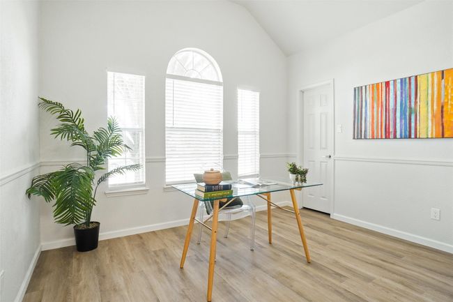 Office area with vaulted ceiling, healthy amount of natural light, light wood-type flooring, and baseboards | Image 18