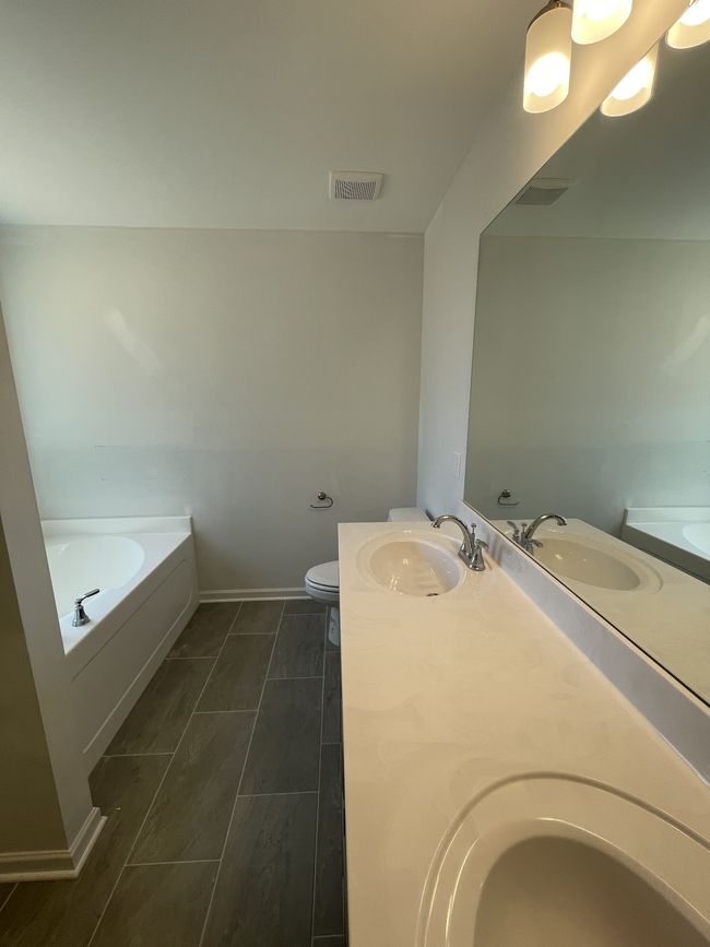 double sinks and tile flooring in primary bathroom | Image 9