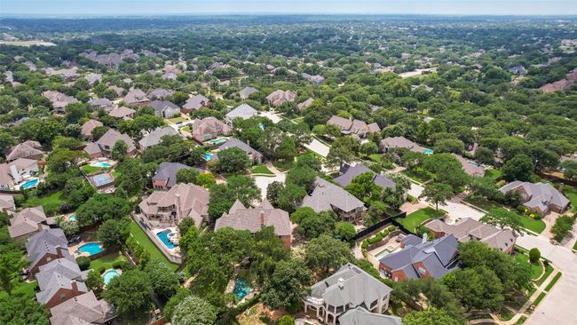 This is the aerial view looking at the back of the house with pool, waterfall and tree covered private backyard. | Image 38