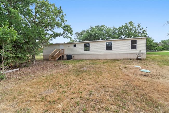 Rear view of house featuring central air condition unit and a yard | Image 15