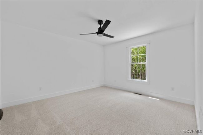 Empty room featuring ceiling fan, carpet flooring, and visible vents | Image 25