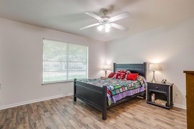 Bedroom featuring wood finished floors and ceiling fan | Image 27