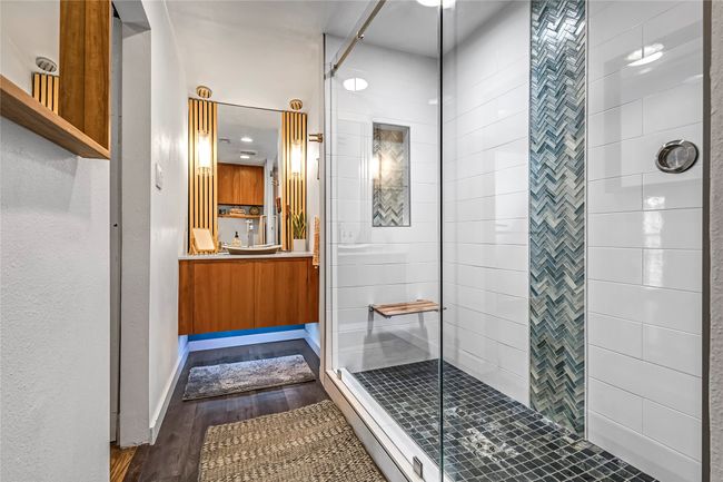 Bathroom with wood finished floors, a stall shower, and vanity | Image 26