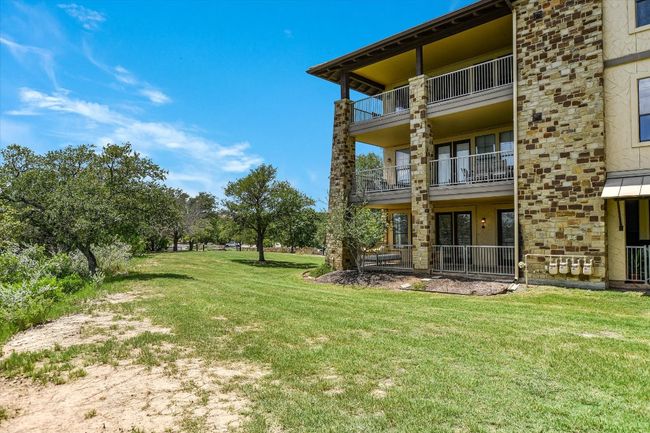 View of grassy yard. The condo is on the first floor, walk out to back. | Image 18