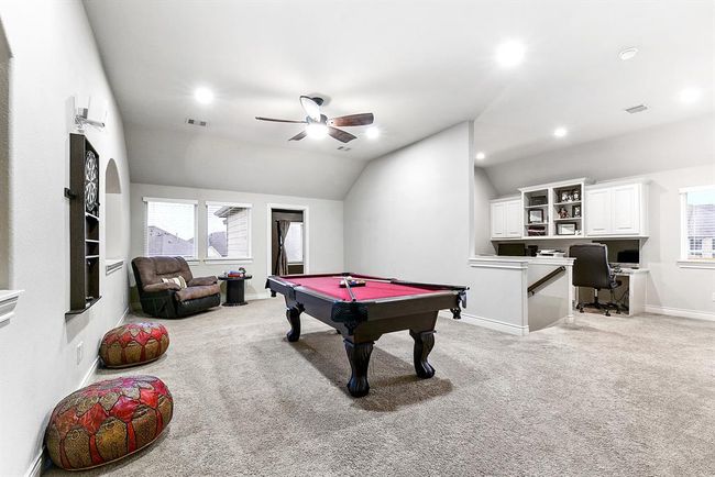 This view highlights the layout of the upstairs, showcasing the game room, media room, and office space, all thoughtfully separated from the bedrooms. This design provides a perfect balance of privacy and entertainment, with distinct areas for work and play, ensuring a comfortable flow throughout the home. | Image 27