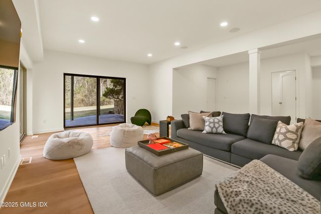 Lower level leads out to slate patio via two sets of slider doors at the corner of the room | Image 37