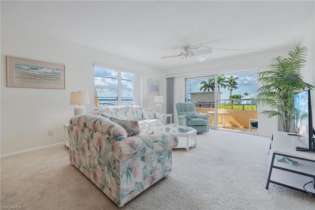 Living room with ceiling fan, a healthy amount of sunlight, and light colored carpet | Image 7