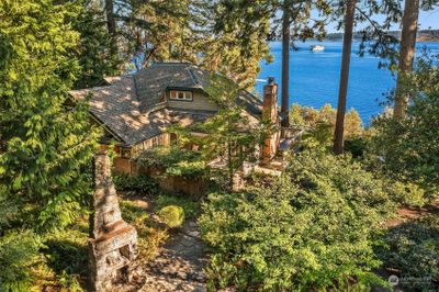 The home is nestled amongst tall trees with gorgeous southern views of Puget Sound, Mt. Rainier and Tacoma. | Image 2