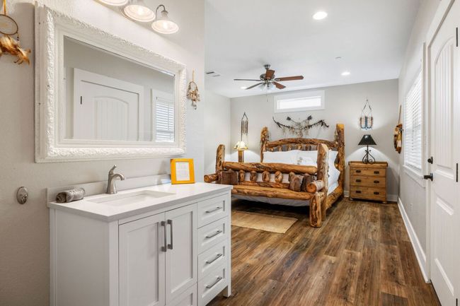 Bedroom with a sink, dark wood-style flooring, recessed lighting, and ceiling fan | Image 36
