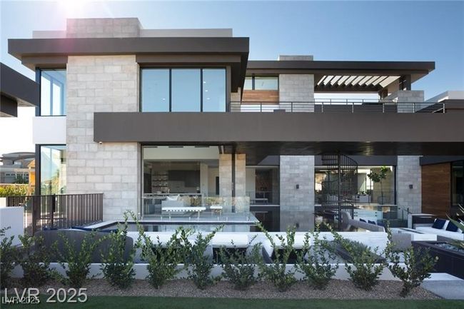 Back of property with a balcony and stone siding | Image 44