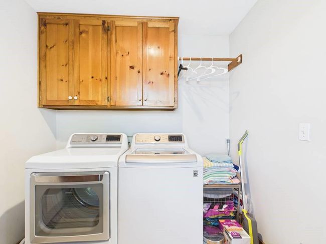 Clothes washing area featuring cabinet space and independent washer and dryer | Image 45