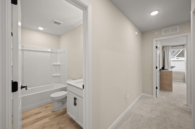 Shared bathroom in the upper level with Luxury Vinyl flooring and quartz vanity | Image 22